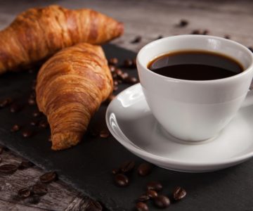 Breakfast with fresh croissants and cup of coffee